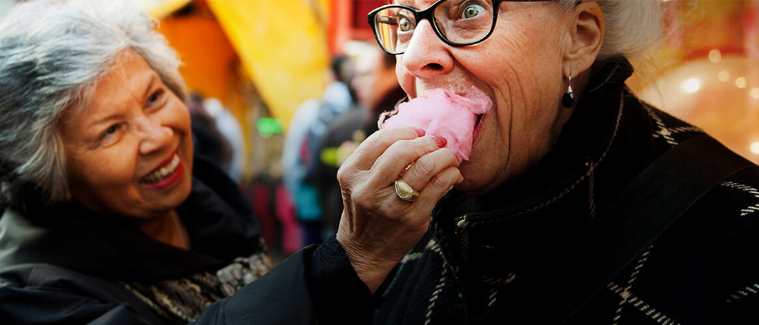 two women eating candy floss