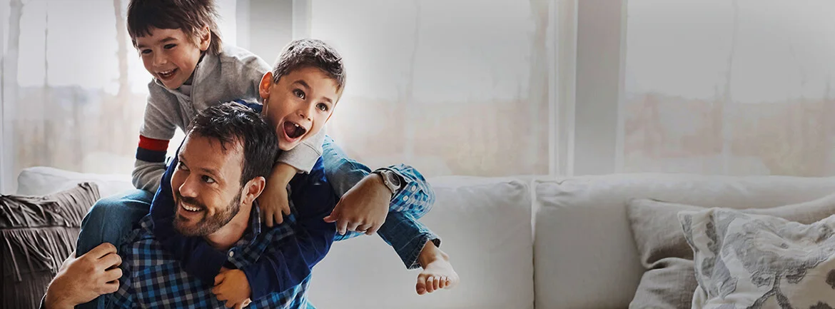 a man holding two children