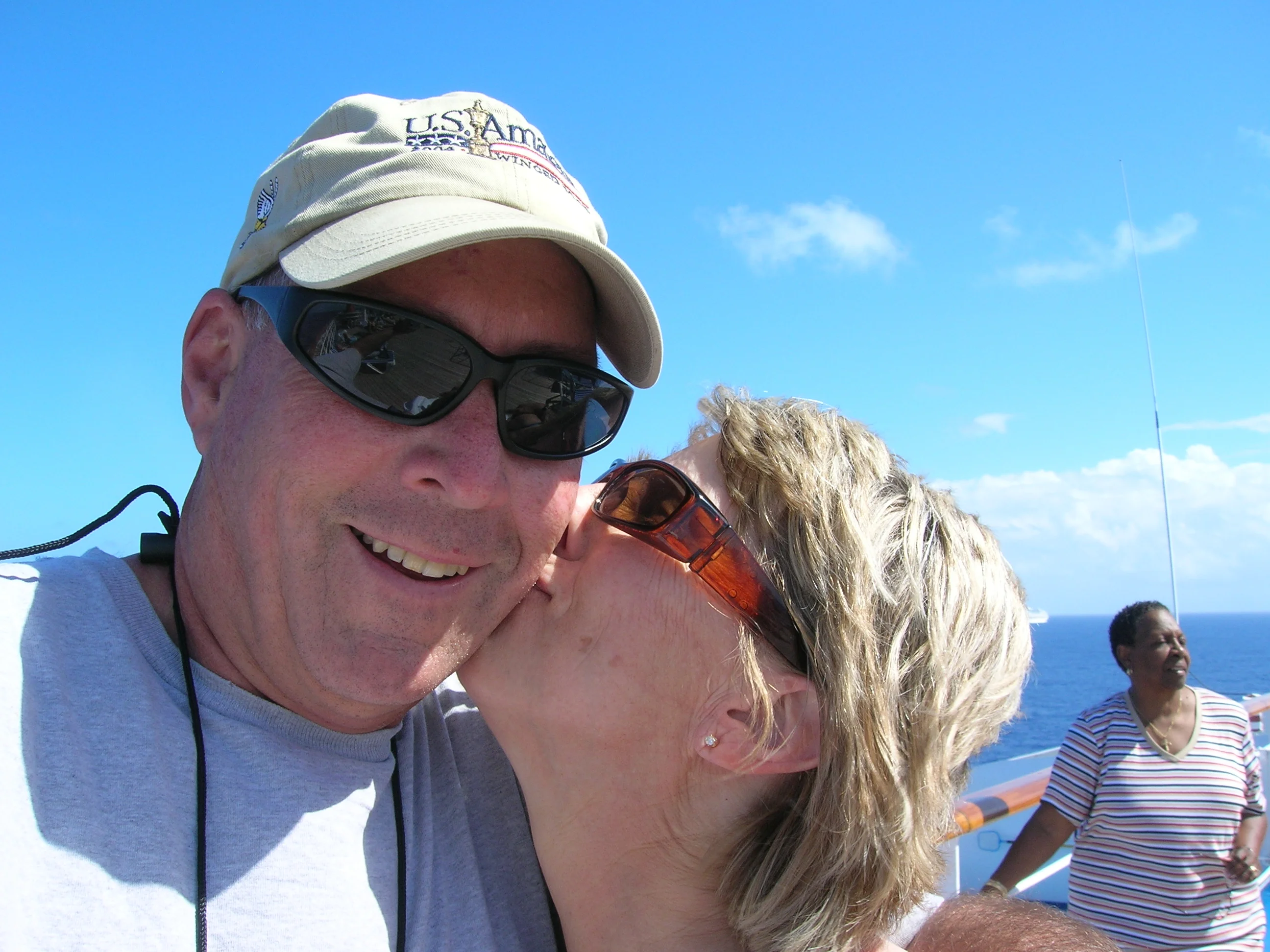 a man kissing a woman on the cheek
