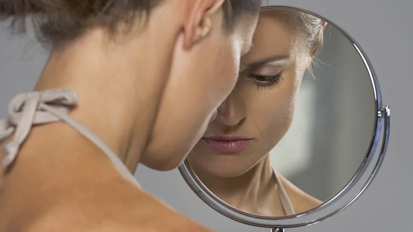 a person looking at a mirror