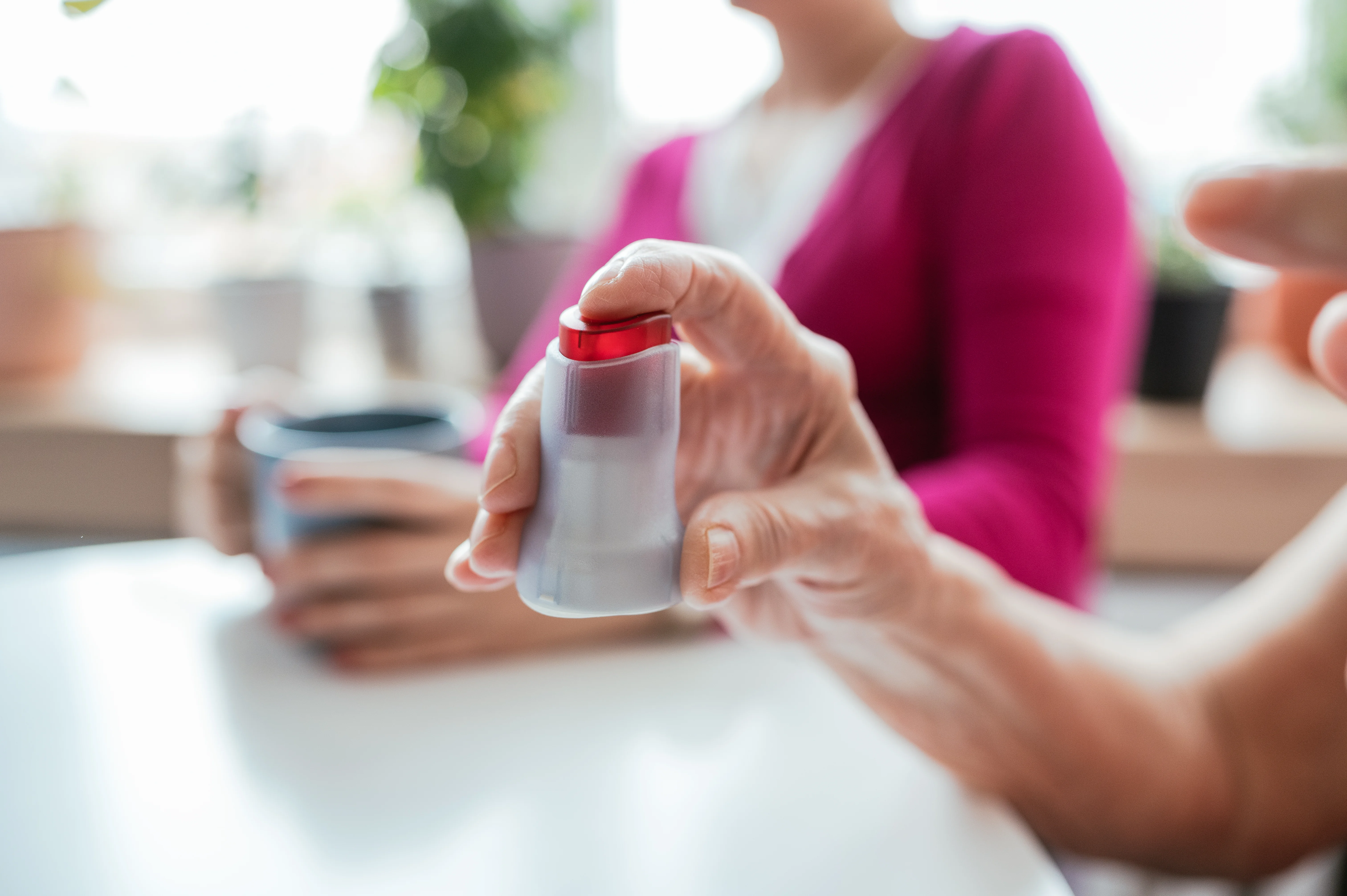 A lady is holding an Neria Guard infusion set